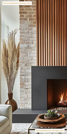 a living room with a fire place and couches in front of a brick wall