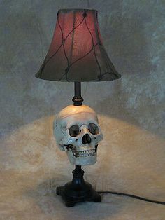 a skull lamp with a red shade on it