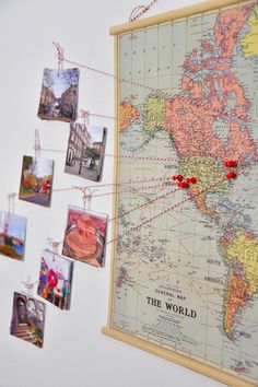 an old world map hanging on the wall with pins pinned to it's sides