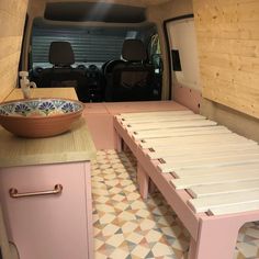 the interior of a van with a table and bowl on it's counter top