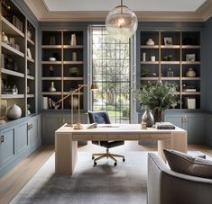 a home office with built - in bookcases and desk