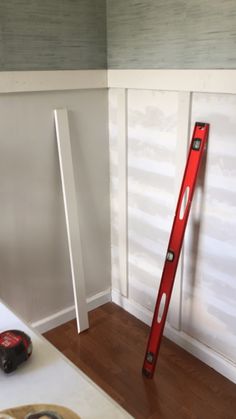 a red ladder leaning up against the wall