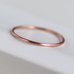 Skinny and minimal round midi ring, stacking ring, or wedding band. Made of 100% recycled materials. 0.8mm Round Ring 14k Rose Gold Size 2.75 Matte Finish 14k Rose Gold Stackable Rings, Minimalist Stackable 14k Rose Gold Rings, Minimalist 14k Rose Gold Stackable Round Band Rings, Minimalist 14k Rose Gold Stackable Rings, Dainty Rose Gold Stackable Rings For Everyday, Minimalist Hypoallergenic Stackable Rings In Rose Gold, Minimalist Hypoallergenic Rose Gold Stackable Rings, Minimalist Hypoallergenic Stackable Rose Gold Rings, Simple 14k Rose Gold Stackable Rings