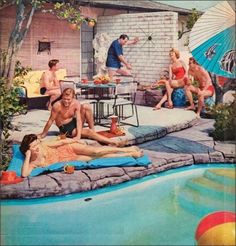 a group of people sitting around a swimming pool