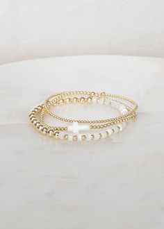 "❖Radiance Stack❖ * An elevated stack of everyday bracelets!  ‣ This listing offers the option of purchasing the stack of 3, or individual bracelets. ‣ Buy more, save more - applied at checkout      * 3 10% off      * 5, 15% off      * 7, 20% off ‣ Radiance Stack features 3 bracelets: * Britt - Mother of Pearl * Wren - Mother of Pearl Cross * Myla 2mm - 14k Gold Filled Julisa Bracelets Feature:  ‣ Tight/Sturdy elastic, pre-stretched to prevent bracelet from stretching out ‣ Sizing according to wrist size ‣Sizing Tips:  Please measure your wrist for the best fit!  *Using a soft tape measure/string, measure around your wrist, above the wrist bone *Add length according to your desired fit:       * 0\" - fitted, snug      * .25\" - slight movement      * .5\" -  comfortable movement      * .75 Wwjd Bracelet Stack, Gold Filled Bracelet Stack, Preppy Gold Bracelet Stack, Christian Bracelet Stack, Gold Stacking Bracelets, Thing To Add To Your Christmas List, Gold Bracket Stack, Gold Filled Beaded Bracelets, Beaded Gold Bracelet