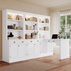 a white desk and bookshelf in a room