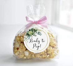 a bag filled with popcorn sitting on top of a table