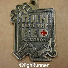 a run for the red marathon medal hanging on a wall in front of a brown background