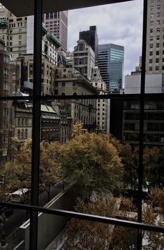 the view from an office building looking out at buildings and trees in the foreground