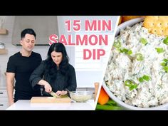 a man and woman standing in front of a bowl filled with food next to a sign that reads 15 min salmon dip