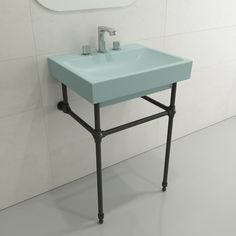 a bathroom sink sitting on top of a metal stand