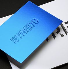 a blue business card sitting on top of a black and white paper with the word enterprise printed on it