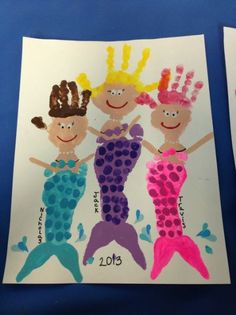 two children's handprints depicting mermaids