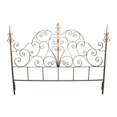 a wrought iron bed frame with scroll designs