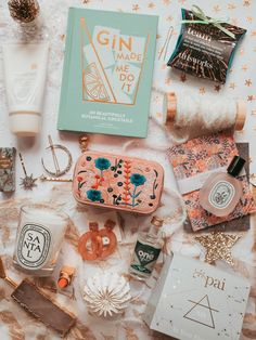 the contents of an assortment of personal care products on a white tablecloth with gold stars