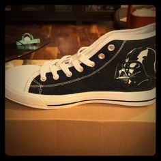 a pair of black and white shoes with a darth vader face on them