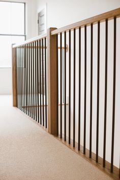 an empty room with white walls and wooden railings