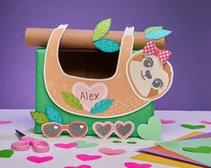 a cardboard box with a slotty bear on it and some paper hearts around it