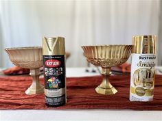 the table is set up with gold dishes and spray paint on it, along with other decorative items