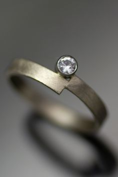 a close up of a ring with a diamond on it