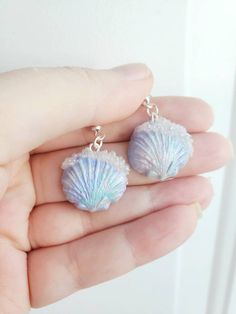 How pretty are these seashell earrings!?! light weight and comfortable!! A great unique gift for yourself or others! Hand sculpted blue pearl like iridescent seashell with clear bubbles! FREE GIFT WITH EVERY ORDER! Check out my other cute designs!! https://www.etsy.com/ca/listing/1266057299/pearl-mermaid-earringssea-shell https://www.etsy.com/ca/listing/1266078141/pastel-mermaid-earringssea-shell Ocean-inspired Single Earring As Gift, Ocean-inspired Shell Earrings For Gifts, Ocean-inspired Shell-shaped Earrings For Gifts, Ocean-inspired Drop Earrings For Gifts, Resin Dangle Earrings For Beach, Ocean-inspired Shell Earrings With Ear Wire, Ocean-inspired Shell Earrings, Ocean-inspired Shell Earrings As Gift, Unique Shell-shaped Earrings For Gift