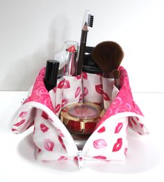 a pink and white bag with makeup on it