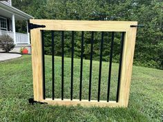 a wooden box with black bars is in the grass