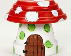 a red and white mushroom shaped object sitting on top of a table