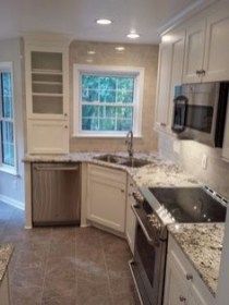 a kitchen with marble counter tops and white cabinets