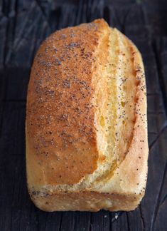 a loaf of bread sitting on top of a wooden table