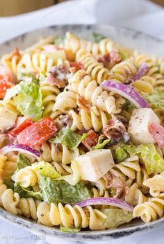 a bowl filled with pasta salad on top of a table