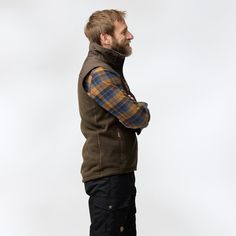 Warm, thick fleece vest that is knitted on the outside and softly brushed on the inside. G-1000 reinforcement across the shoulders for extra durability, which is practical when carrying a backpack. Perfect as a warm middle layer when skiing and can also be worn when you are relaxing in the cabin. Two side pockets and one breast pocket. Zipper in the front with protective flap at the chin. Regular fit. Winter Outdoor Vest With Fleece Lining, Sleeveless Vest With Fleece Lining For Outdoor Activities, Functional Sleeveless Vest With Fleece Lining, Winter Sleeveless Vest For Outdoor Work, Winter Vest With Fleece Lining For Outdoor Activities, Outdoor Fall Vest With Fleece Lining, Functional Windproof Vest For Winter, Functional Windproof Winter Vest, Winter Hiking Vest With Fleece Lining