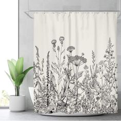 a shower curtain with an image of wildflowers in black and white on it