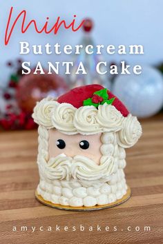 a close up of a cake on a table with the words mini buttercream santa cake