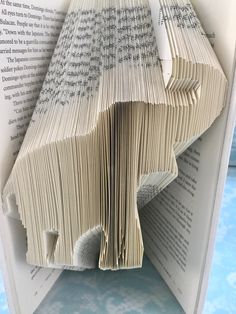 an open book with pages folded in the shape of a tree