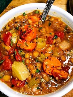 a white bowl filled with stew and vegetables