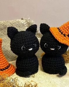 two crocheted black cats sitting next to each other