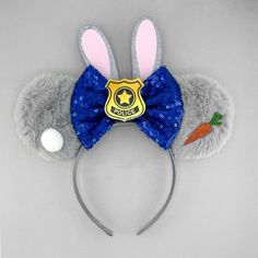 a gray and blue mouse ears with a soccer badge on it