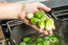 someone is cooking brussel sprouts in a pan on the stove