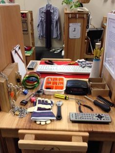 the desk is cluttered with many items and keys, including a calculator