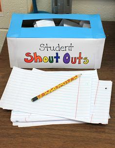 a student's notebook and pen sitting next to a box with writing on it