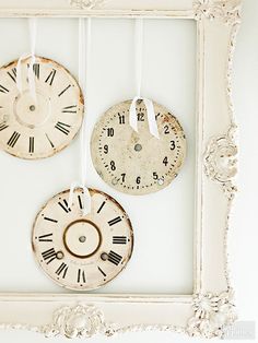 three clocks are hanging on the wall