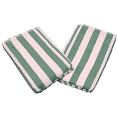 two green and white striped towels sitting next to each other