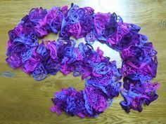 purple flowers are arranged on a wooden table