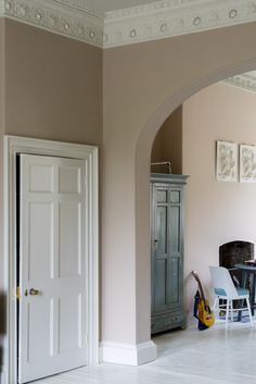 a living room filled with furniture next to a doorway