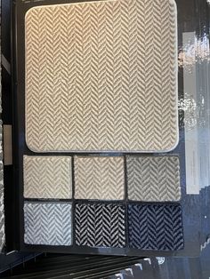 the interior of a store display case with several different patterns on it and one black and white color scheme