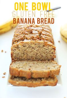 a loaf of banana bread sitting on top of a white plate next to some bananas