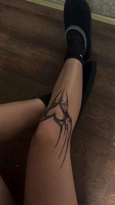 a woman's legs with tattoos on them