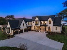 this is an aerial view of the house at dusk, with its driveway and garage