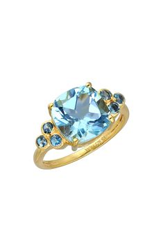 A brilliant-cut London blue topaz stone centers an 18-karat gold-plated ring with gleaming prongs that offer brilliant shine. 18k gold plate/blue topaz Imported Gold Topaz Ring With Gemstone Accents, Gold Cushion Cut Topaz Ring, Elegant Gold Ring With Blue Topaz, Gold Birthstone Ring With Blue Topaz And Accent Stones, Elegant Gold Birthstone Ring With Blue Topaz, Gold Blue Topaz Birthstone Ring With Prong Setting, Gold Cushion Cut Topaz Ring For Anniversary, Formal Gold Birthstone Ring With Blue Topaz, Yellow Gold Blue Topaz Ring With Center Stone